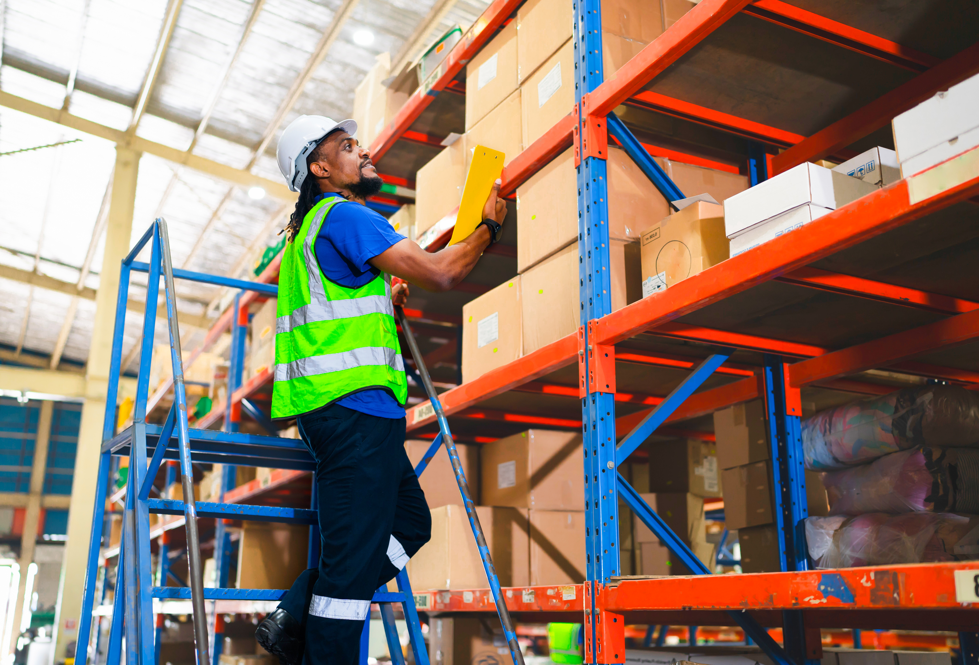 A man loading boxes in a warehouse A man loading boxes in a warehouse