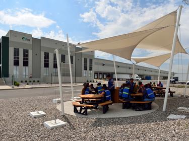 Team members meeting under an awning