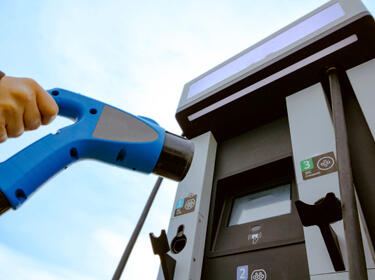 Person Removing EV Charger For Fleet Electrification
