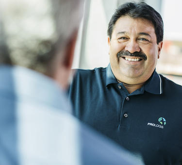 Maintenance technician David Huajardo smiling at a coworker